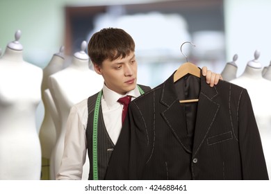 Taylor Holds A Handmade Mans Suit