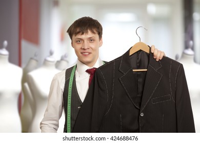 Taylor Holds A Handmade Mans Suit