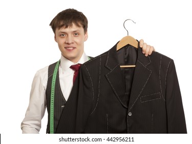 Taylor Holds A Handmade Mans Suit Isolated On A White Background