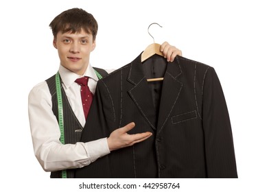 Taylor Holds A Handmade Mans Suit Isolated On A White Background