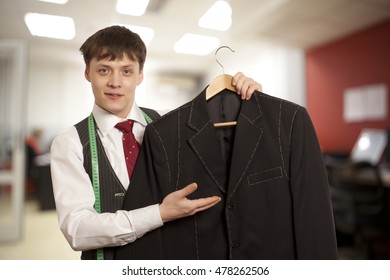 Taylor Holds A Handmade Mans Suit