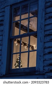 Taylors Falls, Minnesota USA December 18, 2021 Window View Of The Doll House Studio With A Peek Of The Christmas Tree And Lights Wrapped Around A Beam. Building Used As A Photography Studio.