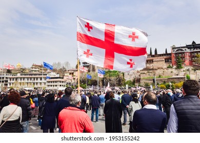 Tbilisi, Georgia - 9th April, 2021: Person Holds Georgian Flag In Street In Peaceful Protest. 