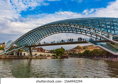 Tbilisi , Georgia - August 25, 2019 : People Tourist On The Bridge Of Peace Landmark Of Tbilisi Georgia Capital City Eastern Europe