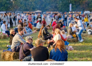 Tbilisi, Georgia - May 1, 2022: Crowd Of People Sitting On Grassy Lawn During Concert On Summer Weekend Day In City Park