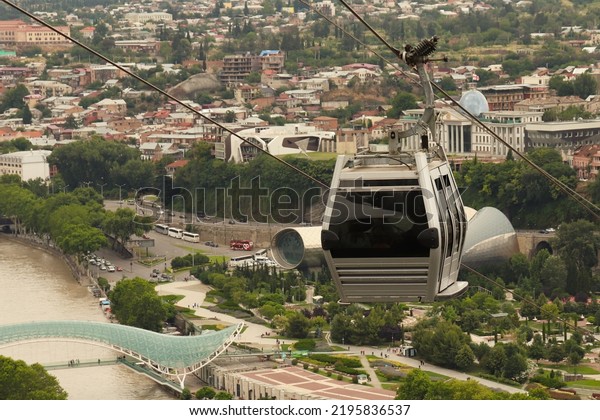 Tbilisi,\
Georgia-10.07.2022:Gondola cabin of the cable car, cable car cabin,\
bird\'s eye view of the\
city