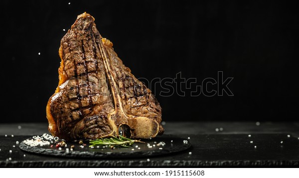 The T-bone or porterhouse steak of\
beef cut from the short loin. steaksT-shaped bone with meat on each\
side. banner, catering menu recipe place for\
text.