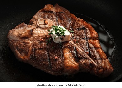 T-bone Steak Cooked In A Grill Pan With Rosemary And Butter. Premium Beef Steak On The Bone, Close-up