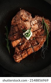 T-bone Steak Is Fried In A Grill Pan With Spices, Butter And Smoke. Premium Porterhouse Beef Steak On The Bone, Top View