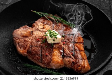 T-bone Steak Is Fried In A Grill Pan With Spices, Butter And Smoke. Premium Porterhouse Beef Steak On The Bone