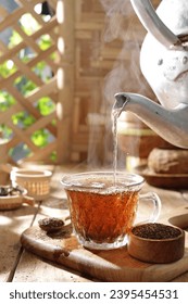 Tea is an aromatic beverage prepared by pouring hot or boiling water over cured or fresh leaves of Camellia sinensis, an evergreen shrub native to East Asia which probably originated in the borderland - Shutterstock ID 2395454531