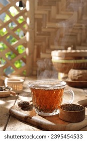 Tea is an aromatic beverage prepared by pouring hot or boiling water over cured or fresh leaves of Camellia sinensis, an evergreen shrub native to East Asia which probably originated in the borderland - Shutterstock ID 2395454533