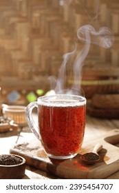 Tea is an aromatic beverage prepared by pouring hot or boiling water over cured or fresh leaves of Camellia sinensis, an evergreen shrub native to East Asia which probably originated in the borderland - Shutterstock ID 2395454707