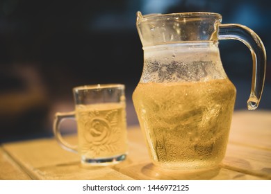 Tea or Beer in an ice jug with water droplets. In Night Club Background