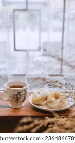 tea break with donuts in wooden table  near window - Shutterstock ID 2364866789