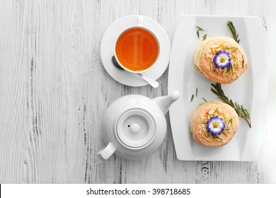 Tea with cakes on wooden background, top view - Shutterstock ID 398718685