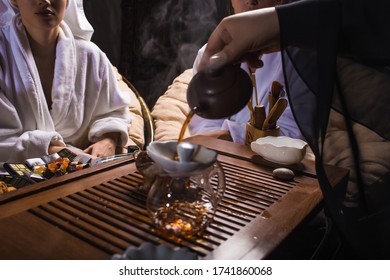 Tea ceremony after the sauna. Girls in white coats drink Chinese tea - Shutterstock ID 1741860068