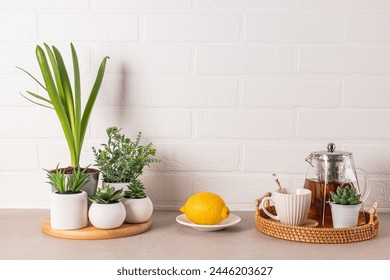 Tea Ceremony Items Set on Kitchen Stone Countertop with Potted Plants White Brick Wall. A copy space. Kitchen background - Powered by Shutterstock