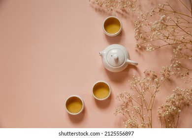 Tea ceremony set. White tea cups and teapot. Green herbal tea. Top view with copy space. Natural background - Powered by Shutterstock