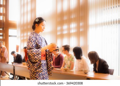 Tea ceremony: waitress in kimono was bringing tea to guests