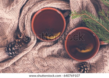 Tea, cones, cozy knitted blanket. Winter, New Year, Christmas still life.