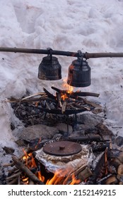 Tea cooked on fire. Cooking food and tea in earthen pots over the campfire.
