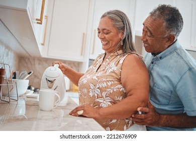 Tea, Couple And Retirement With A Man And Woman Using A Kettle In The Kitchen Of Their Home Together. Love, Morning And Romance With A Senior Male And Woman Making A Coffee Beverage In Their House