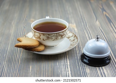 Tea In A Cup And Biscuits, Staff Call Bell. Concept: Good Morning, Tea Time, Breakfast.