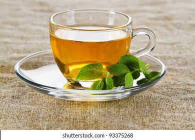 Tea cup with fresh mint leaves, closeup photo