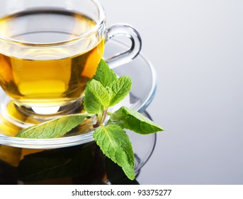 Tea cup with fresh mint leaves, closeup photo