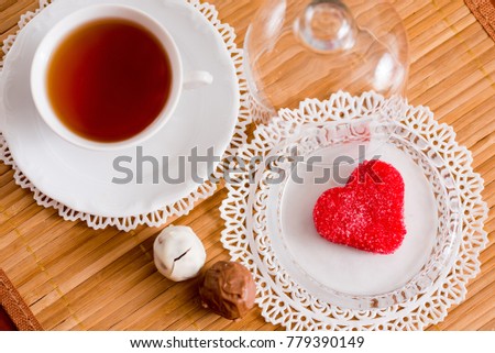 tea cup with heart shaped biscuits. Sugar red biscuits.
