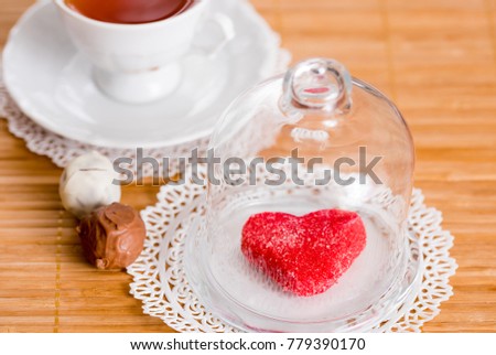 tea cup with heart shaped biscuits. Sugar red biscuits.