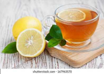 Tea Cup  With Lemon On A Wooden Table