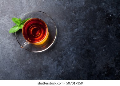 Tea Cup With Mint On Stone Table. Top View With Copy Space