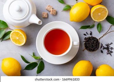 Tea Cup And Pot With Lemon. Grey Background. Close Up. Top View.