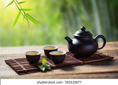 tea cup and teapot on wood plank outside the door