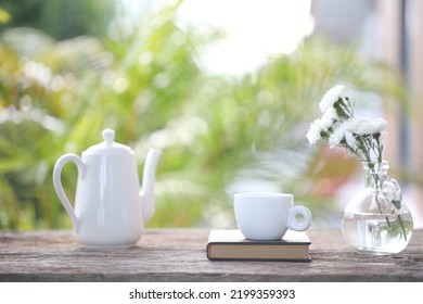 Tea Cup And White Tea Pot With White Chrysanthemum In Vase