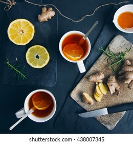 Tea cups with black tea, lemon, ginger