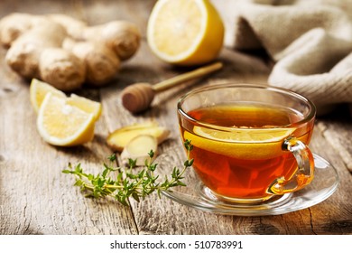 Tea With Ginger, Lemon And Thyme On An Old Wooden Background