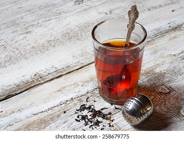 Tea in glass and strainer. Selective focus