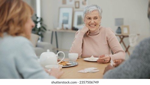 Tea, happy and retirement with friends and playing cards in living room for relax, diversity and poker. Games, smile and community with group of old people in nursing home for party and celebration - Powered by Shutterstock