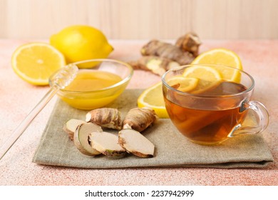 Tea, honey, lemon and ginger on beige textured table - Powered by Shutterstock