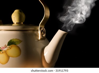 Tea Kettle With Boiling Water On Black Background