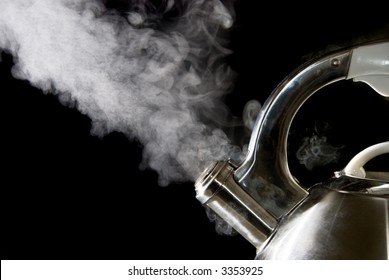 Tea Kettle With Boiling Water; Steam Against A Black Background.