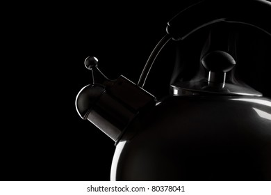Tea kettle over dark background