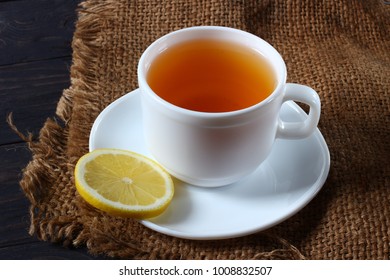 Tea with lemon and oatmeal cookies on a wooden background - Powered by Shutterstock