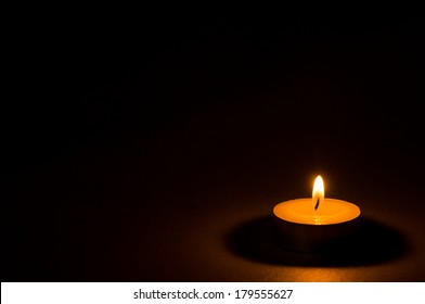 Tea Light Candle On Black Background