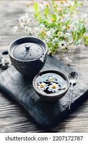 Tea Made From Fresh Chamomile Flowers. Hot Drink, Alternative Medicine. Background Of Old Wooden Boards, Close-up