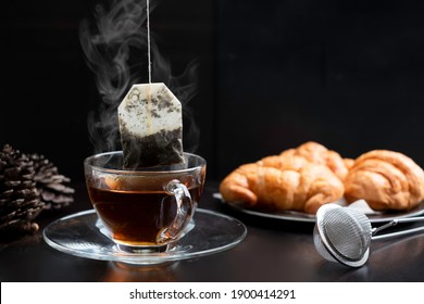 Tea Making By Dipping Tea Bag In Hot Water.  Dipping Herbal Tea Bag Into Cup Of Hot Water Gives Relaxing Aroma Scent For Stress Relief. Dipping Tea Bag And Hot Beverage For Healthy Breakfast Concept.