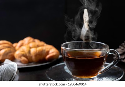 Tea Making By Dipping Tea Bag In Hot Water.  Dipping Herbal Tea Bag Into Cup Of Hot Water Gives Relaxing Aroma Scent For Stress Relief. Dipping Tea Bag And Hot Beverage For Healthy Breakfast Concept.